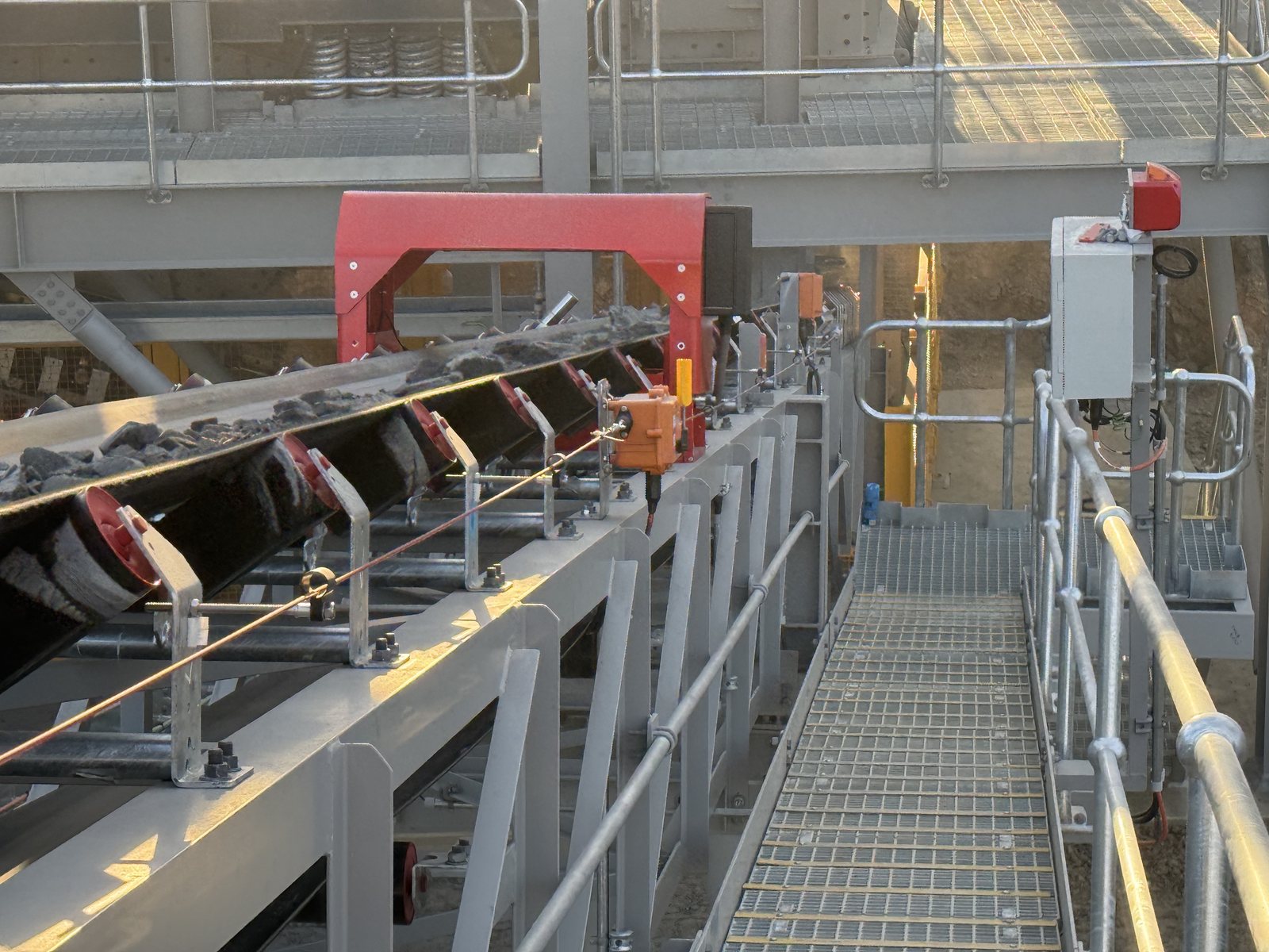Installed TMD frame, balance actuator and controller beside the conveyor walkway